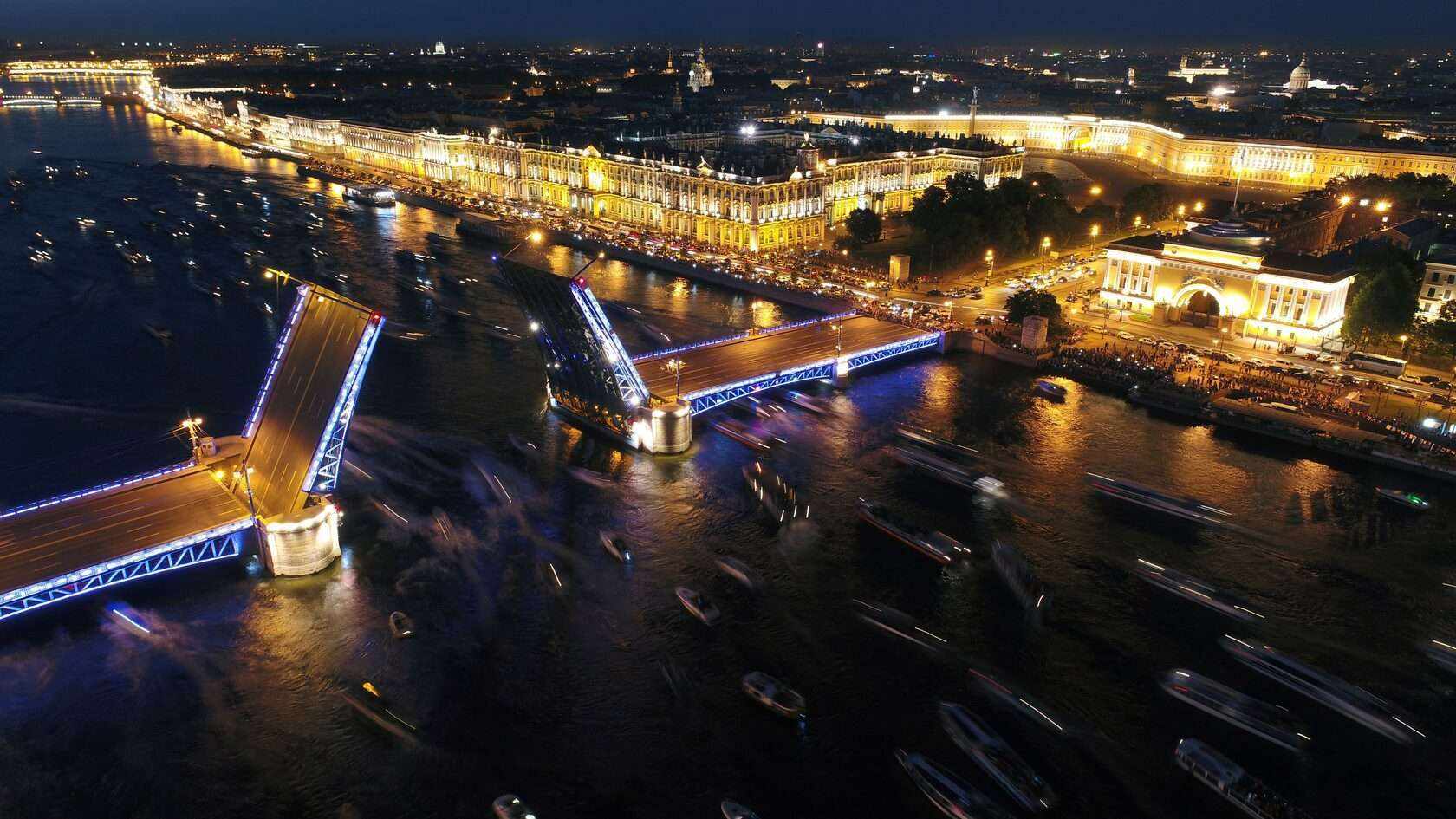 An aerial view of the open Palace Bridge and vessels on the Neva