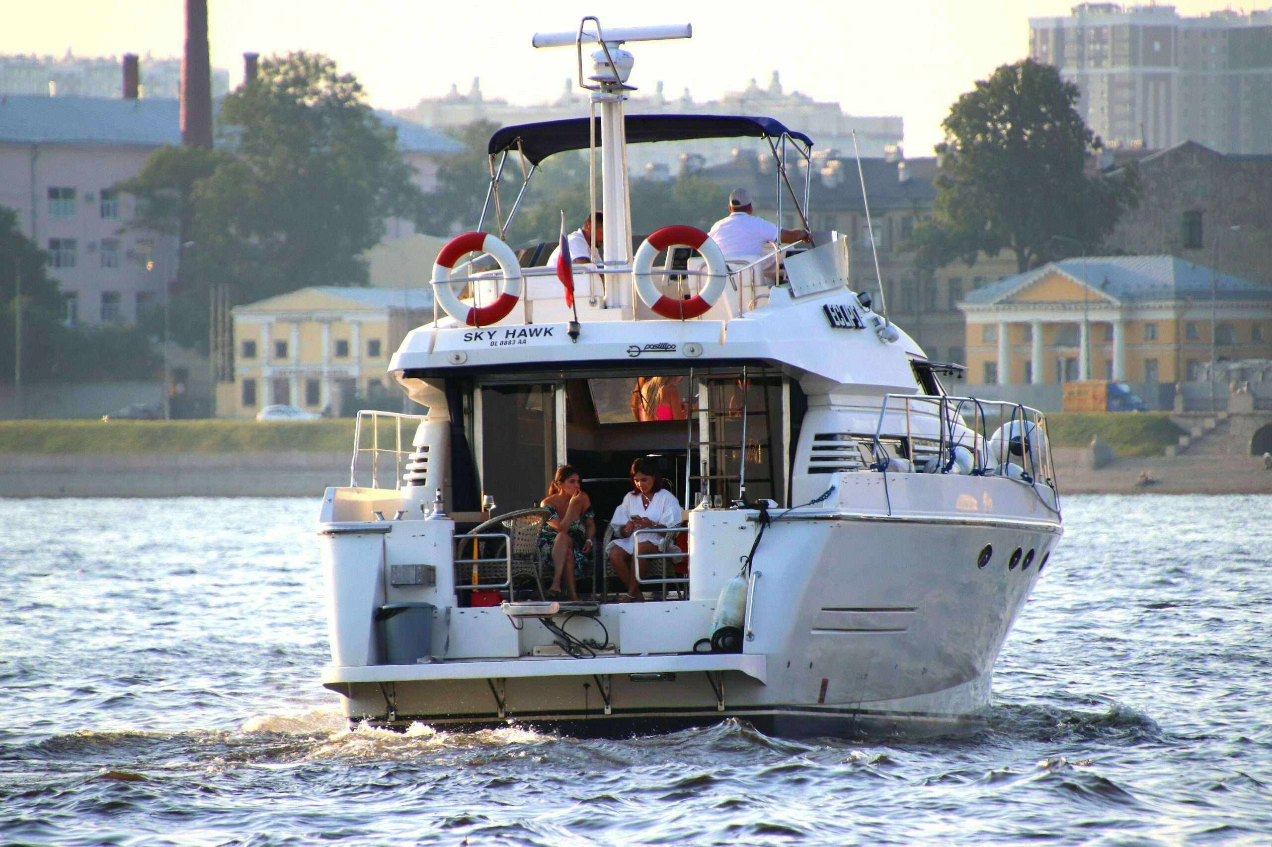 A motor yacht with an enclosed cabin on a city river